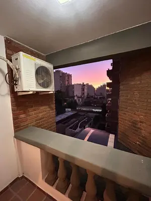 a balcony with a window with a air conditioner at Departamento Artigas in Cordoba