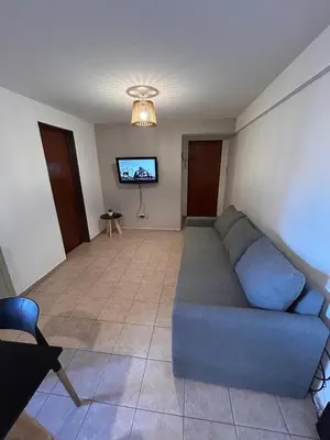 a living room with a couch and a flat screen tv at Departamento Artigas in Cordoba