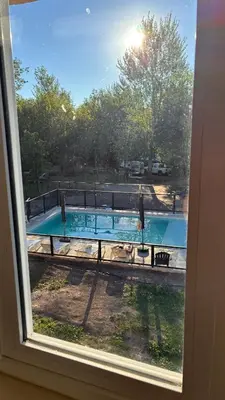 a view of a swimming pool from a window at Tiny House Playa Mansa in Mina Clavero