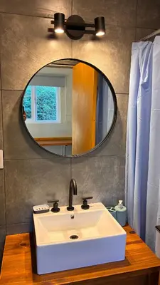 a bathroom with a white sink and a mirror at Tiny House Playa Mansa in Mina Clavero
