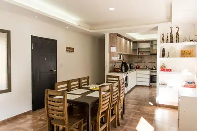 a kitchen and dining room with a table and chairs at Cabañas Imagina in Villa General Belgrano