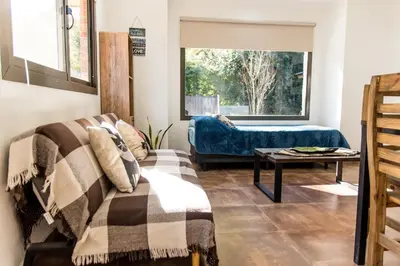 a living room with a couch and a table at Cabañas Imagina in Villa General Belgrano
