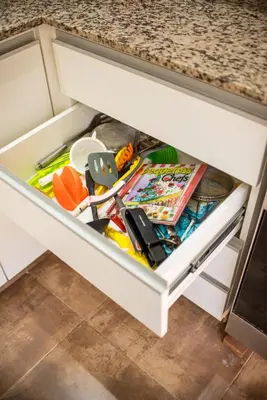 a drawer in a kitchen cabinet filled with food at Cabañas Imagina in Villa General Belgrano