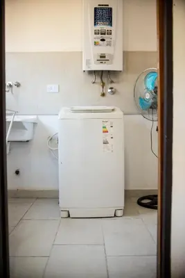 a small refrigerator in a kitchen with a microwave at Cabañas Imagina in Villa General Belgrano