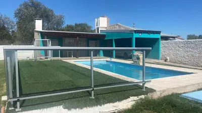 a swimming pool in front of a house at Casa con pileta in Río Cuarto