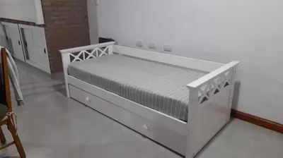 a white bed in a white room with a mattress at Casa con pileta in Río Cuarto
