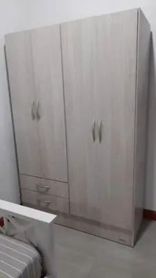 a white cabinet with two doors in a room at Casa con pileta in Río Cuarto