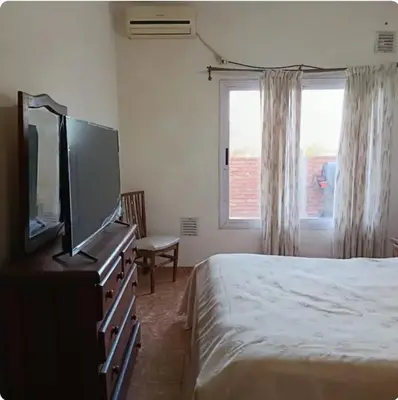 a bedroom with a bed and a flat screen tv at Depto amoblado in Río Tercero