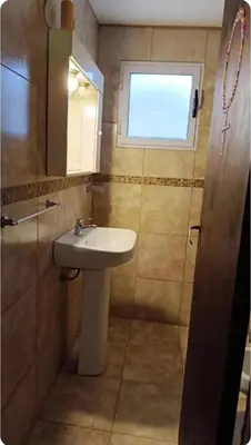 a bathroom with a sink and a window at Depto amoblado in Río Tercero