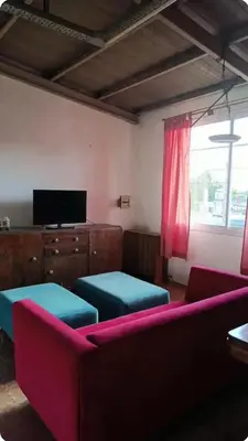 a living room with a couch and a tv at Depto amoblado in Río Tercero