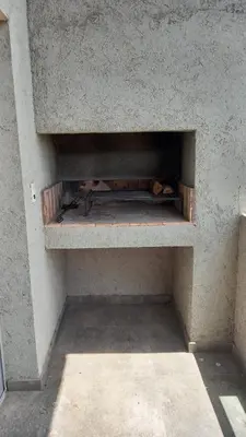 a cat is laying on a shelf in a wall at Carcano Temporarios in Villa Carlos Paz