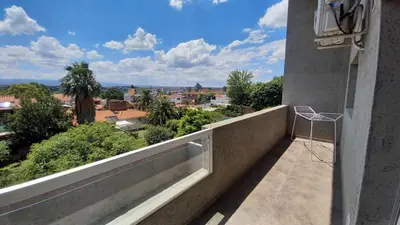 a balcony with a view of a city at Carcano Temporarios in Villa Carlos Paz