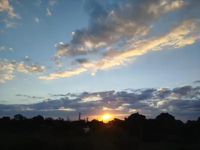 a sunset in the sky with clouds at Entre Tanto in Luyaba
