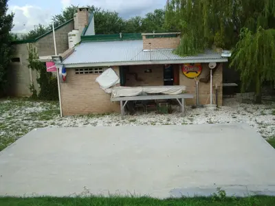 a house with a picnic table in front of it at Casa de Campo con Pileta - Estancia La Amistad in Villa Santa Cruz del Lago