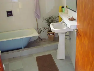 a bathroom with a sink and a toilet and a tub at Casa de Campo con Pileta - Estancia La Amistad in Villa Santa Cruz del Lago