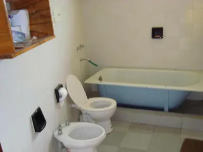 a bathroom with a toilet and a bath tub at Casa de Campo con Pileta - Estancia La Amistad in Villa Santa Cruz del Lago