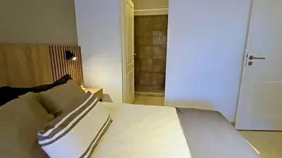 a bedroom with a bed and a door to a closet at Hostel del carlos in Villa Carlos Paz