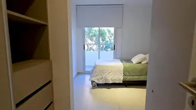 a bedroom with a bed and a window at Hostel del carlos in Villa Carlos Paz
