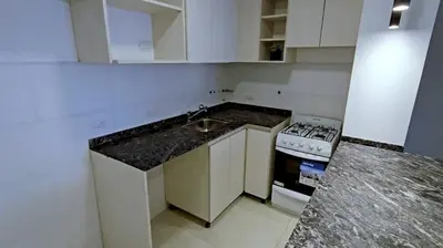 a small kitchen with a sink and a stove at Hostel del carlos in Villa Carlos Paz
