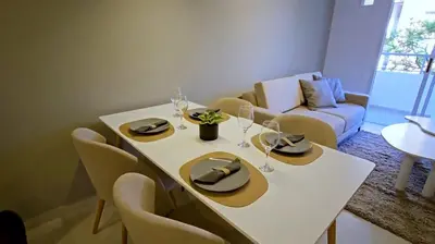 a dining room with a white table and chairs at Hostel del carlos in Villa Carlos Paz