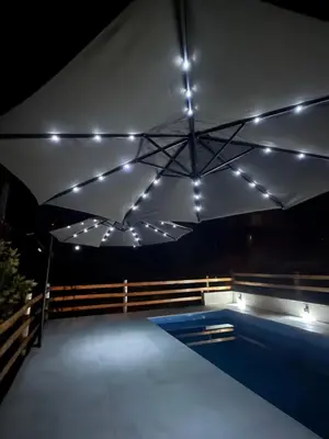 a swimming pool with lights on the ceiling at L&M Cabañas Villa Yacanto in Villa Yacanto