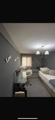 a living room with a bed and a table in it at Vanrod in Cordoba