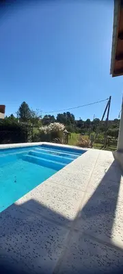 a swimming pool with blue water and a blue sky at Casa los nonos in Cordoba