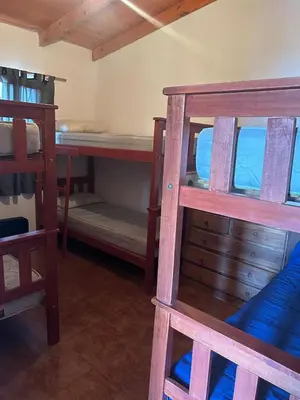 a room with several bunk beds in a room at Alma ina in Villa Yacanto