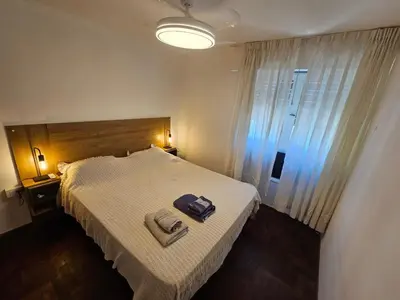 a bedroom with a bed with a bag on it at Nueva Córdoba 3 personas 1 Dormitorio con Balcón in Cordoba