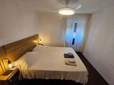 a bedroom with a large bed and a light at Nueva Córdoba 3 personas 1 Dormitorio con Balcón in Cordoba