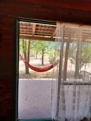a window with a hammock in a room at Bajos de Nono in Nono
