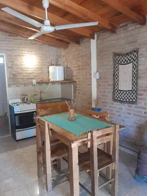 a kitchen with a wooden table and a stove at Bajos de Nono in Nono