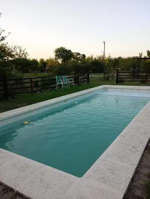 a swimming pool with blue water in a yard at Bajos de Nono in Nono