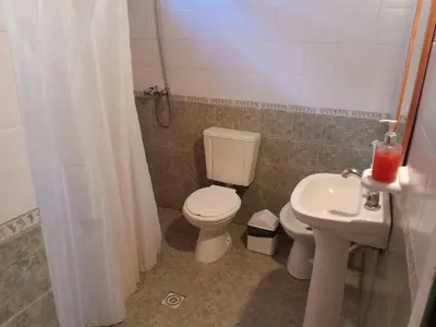 a bathroom with a toilet and a sink at Bajos de Nono in Nono