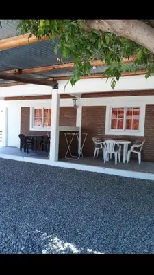 a patio with a table and chairs in front of a building at Postal Serrana 1 in Villa Cura Brochero