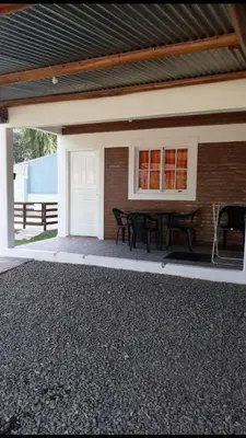 a patio with a table in front of a house at Postal Serrana 1 in Villa Cura Brochero