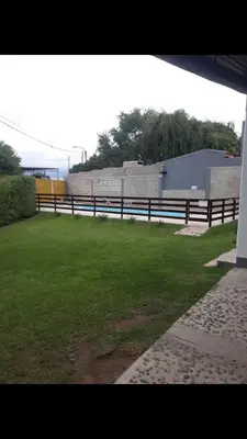 a fence in front of a field of grass at Postal Serrana 1 in Villa Cura Brochero