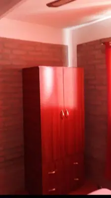 a red cabinet in the corner of a room at Postal Serrana 1 in Villa Cura Brochero