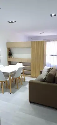a living room with a couch and a table and chairs at Departamento Céntrico Margarita - Villa Carlos Paz in Villa Carlos Paz