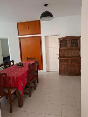 a dining room with a table with a red table cloth at Brothers vcp in Villa Carlos Paz