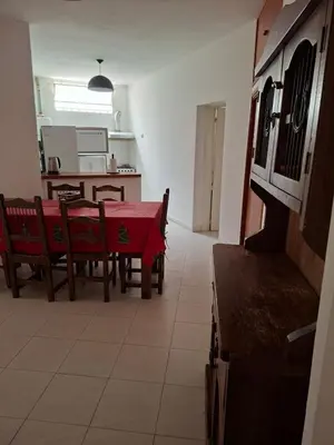 a kitchen and dining room with a red table and chairs at Brothers vcp in Villa Carlos Paz