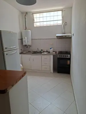 a white kitchen with a sink and a stove at Brothers vcp in Villa Carlos Paz