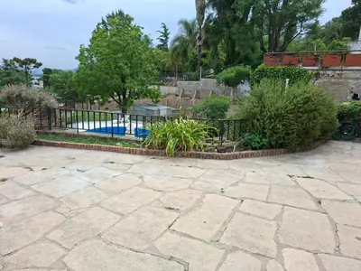 a garden with a fence and a swimming pool at Brothers vcp in Villa Carlos Paz
