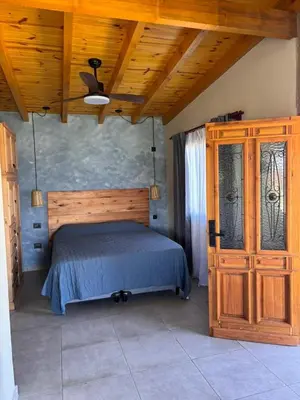 a bedroom with a bed and a wooden ceiling at Las Tacuaritas in Villa Ciudad Parque