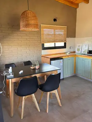 a kitchen with a table and chairs in a room at Las Tacuaritas in Villa Ciudad Parque
