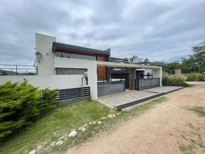 a person standing in front of a house at Homer Renata Goethe 1197 Villa Carlos Paz, Córdoba in Villa del Lago