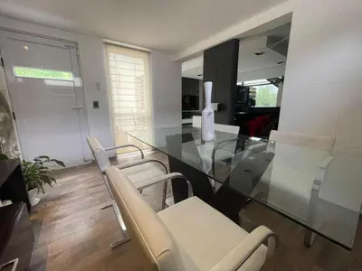 a dining room with a glass table and chairs at Homer Renata Goethe 1197 Villa Carlos Paz, Córdoba in Villa del Lago