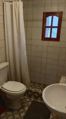 a bathroom with a toilet and a sink at Los árboles in Potrero de Garay