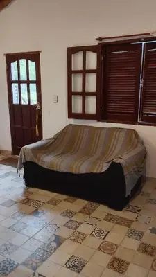 a bed in a room with a tiled floor at Los árboles in Potrero de Garay