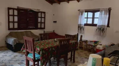 a room with a table and chairs and a bedroom at Los árboles in Potrero de Garay